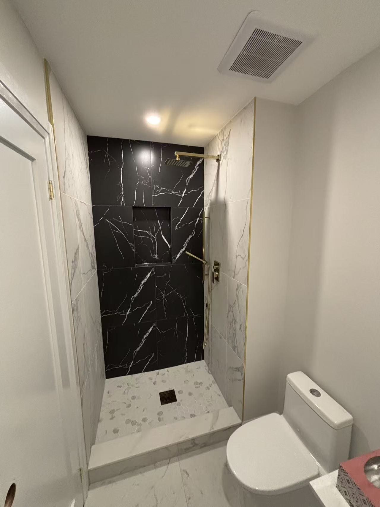 Spacious walk-in shower with rain head fixture