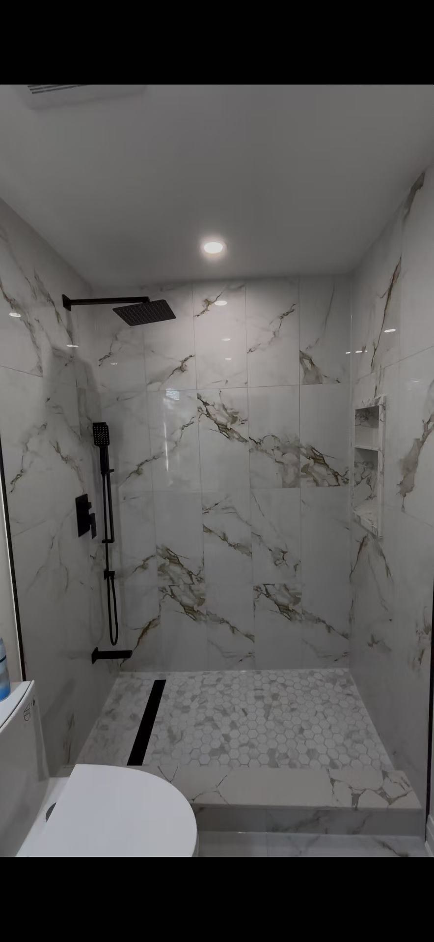 Precision tile layout and glass wall installation