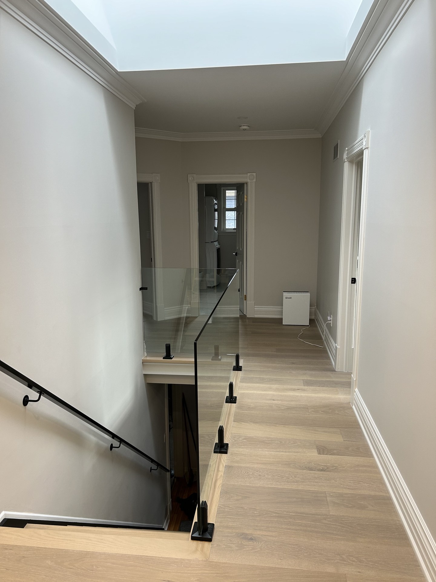 Panoramic view of custom hardwood flooring and crown molding interior